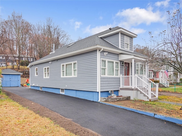 view of front of property with a storage shed