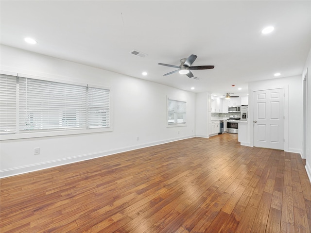 unfurnished living room with ceiling fan and light hardwood / wood-style flooring