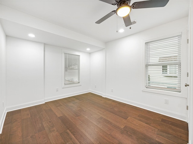 empty room with ceiling fan and dark hardwood / wood-style floors