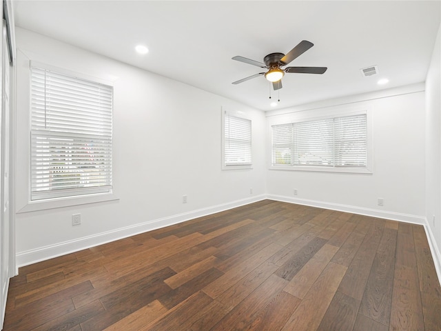 spare room featuring ceiling fan and dark hardwood / wood-style flooring