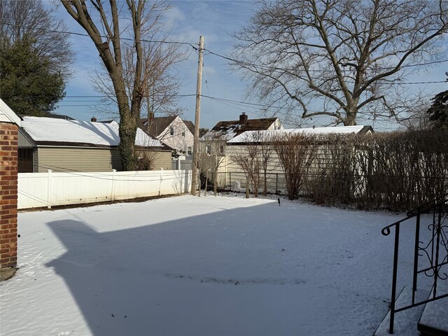 view of yard layered in snow