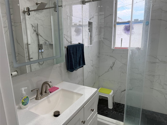 bathroom featuring vanity and a shower with door