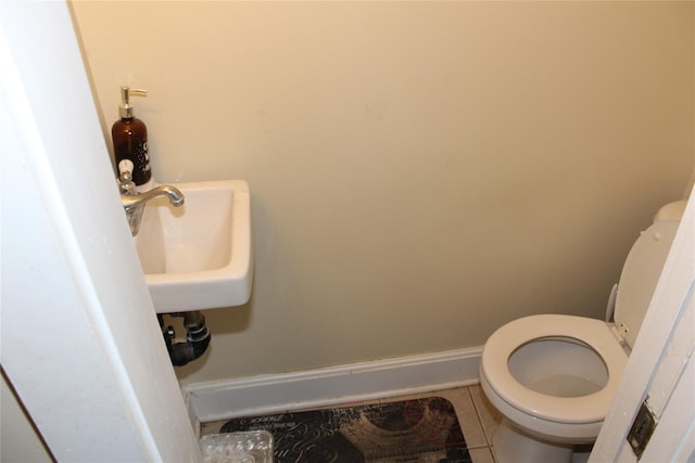 bathroom with tile patterned floors, toilet, and sink