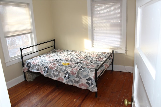 bedroom with dark hardwood / wood-style flooring