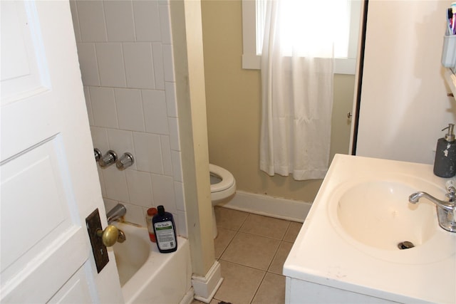 full bathroom featuring vanity, toilet, tiled shower / bath combo, and tile patterned flooring