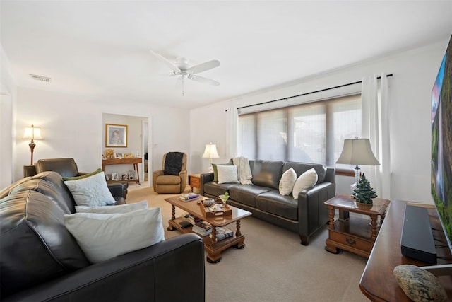 carpeted living room with ceiling fan