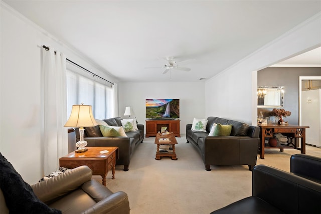 living room with light carpet, crown molding, and ceiling fan