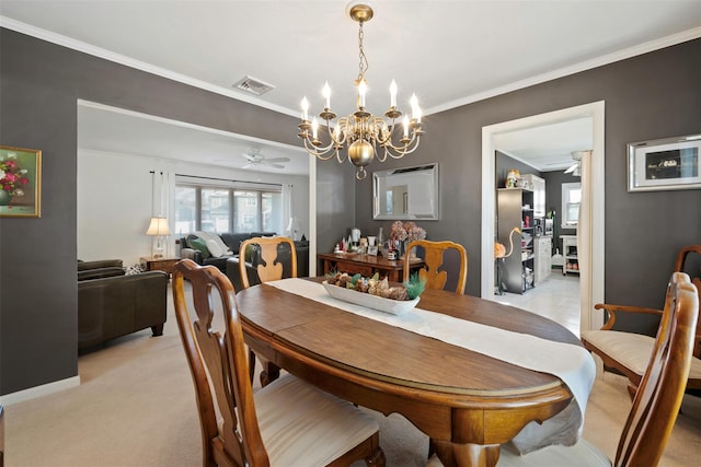 dining room featuring ornamental molding, ceiling fan with notable chandelier, and light carpet