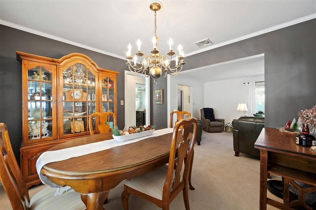 carpeted dining area featuring crown molding and a notable chandelier