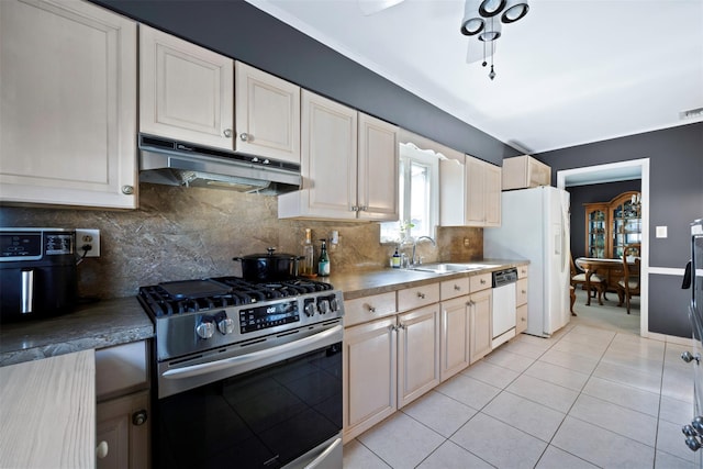 kitchen with white appliances, light tile patterned floors, sink, and backsplash