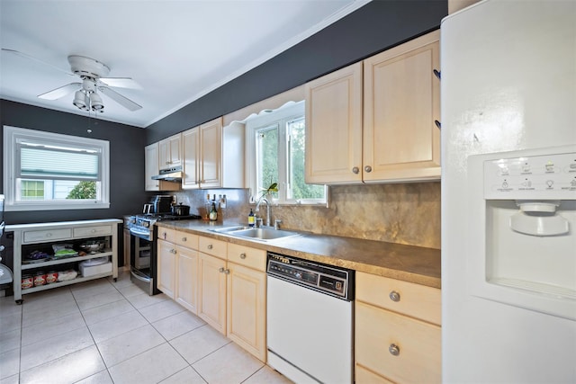 kitchen with sink, white appliances, light tile patterned floors, ceiling fan, and decorative backsplash