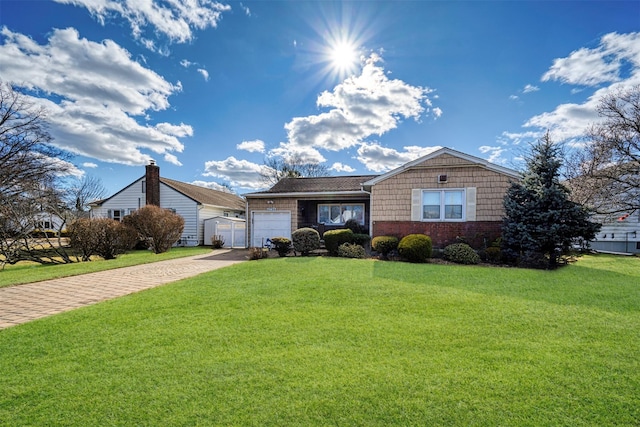 view of front of property featuring a garage and a front yard