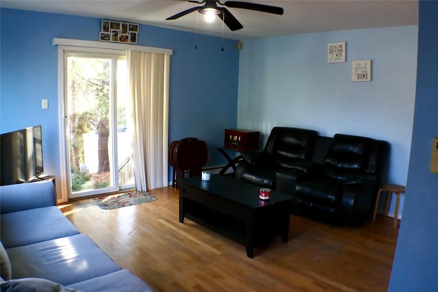 living area featuring wood finished floors and ceiling fan