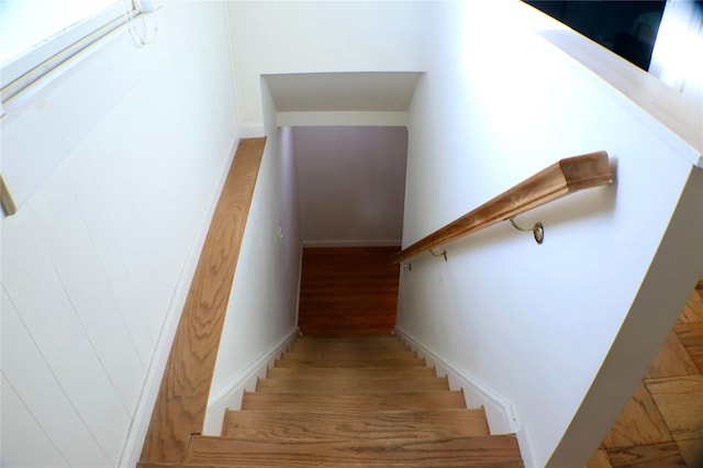 staircase with wood finished floors