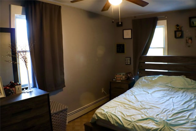 bedroom with baseboards, baseboard heating, and ceiling fan