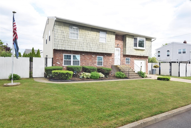 101 Bishop Rd, West Babylon, NY 11704 - bi-level home featuring brick siding, an attached garage, a gate, and driveway