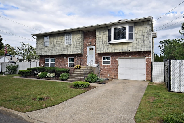 101 Bishop Rd, West Babylon, NY 11704 - bi-level home with brick siding, an attached garage, and driveway