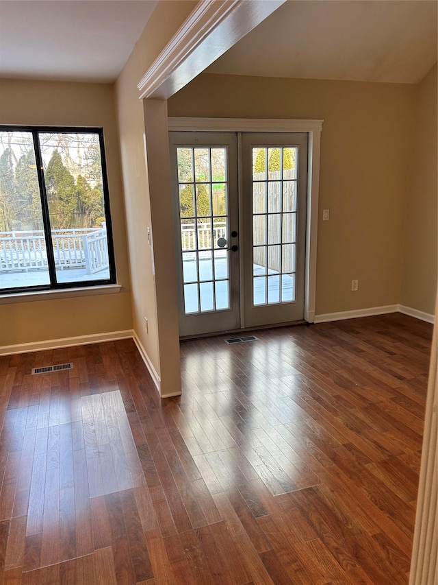 entryway featuring french doors, a healthy amount of sunlight, and dark hardwood / wood-style floors