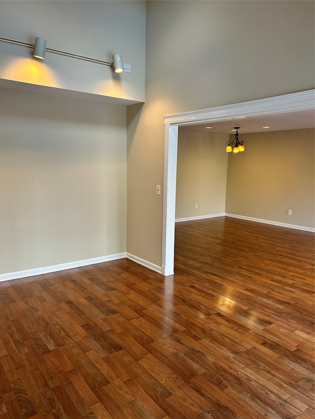 spare room with dark wood-type flooring