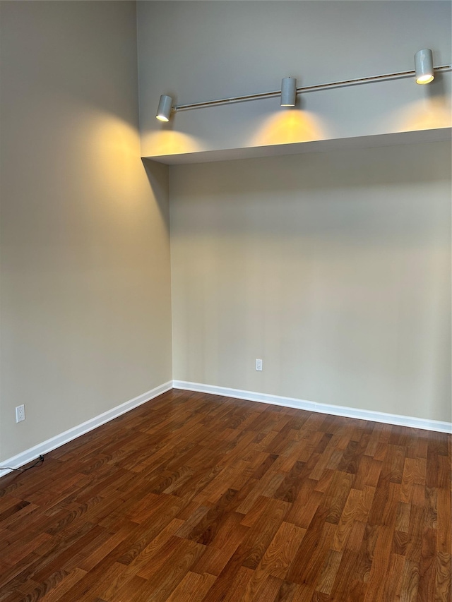 empty room with dark wood-type flooring