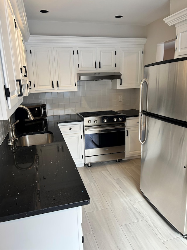 kitchen featuring tasteful backsplash, sink, stainless steel appliances, and white cabinets