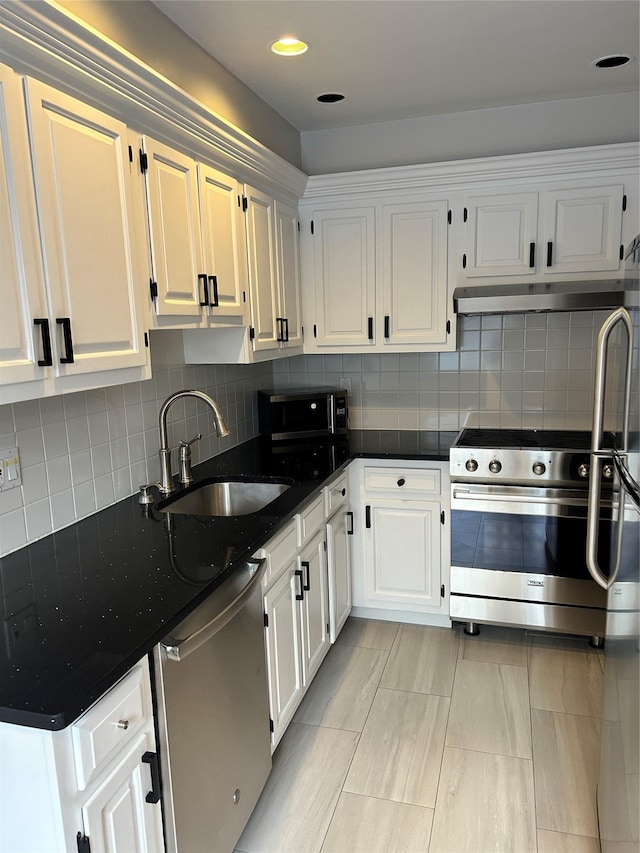 kitchen featuring stainless steel appliances, white cabinetry, and sink