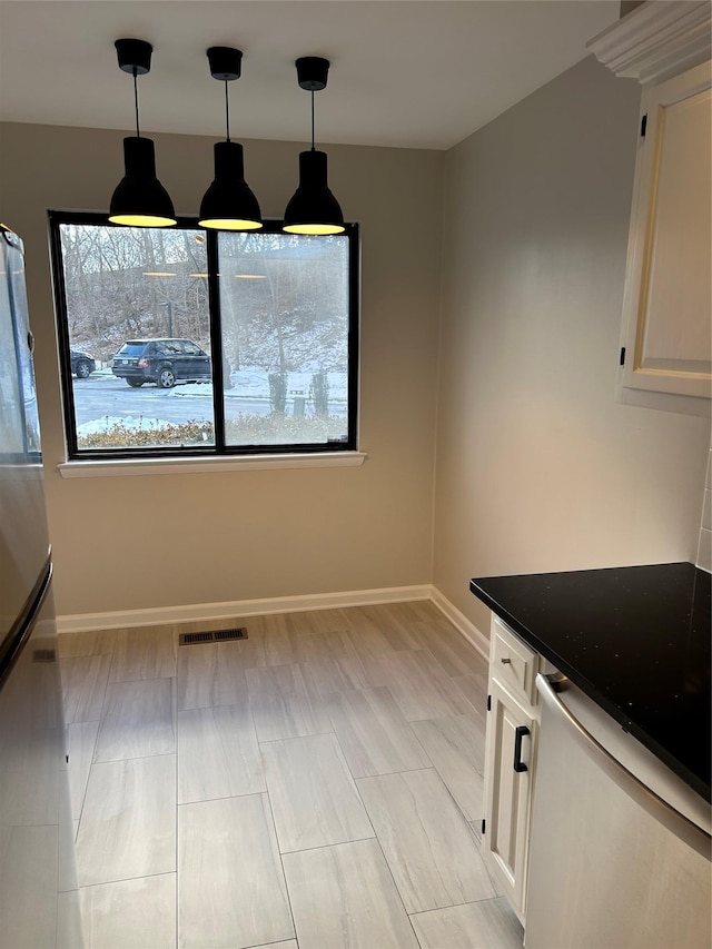 unfurnished dining area with plenty of natural light