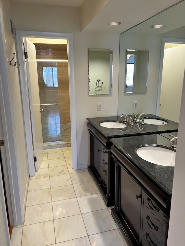 bathroom with vanity and a tile shower