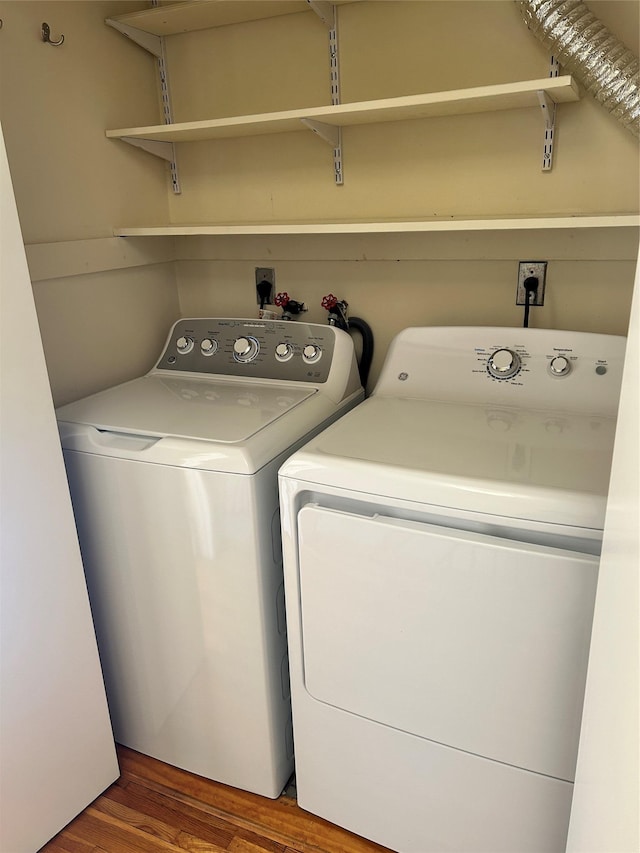 laundry room featuring washer and dryer and hardwood / wood-style floors