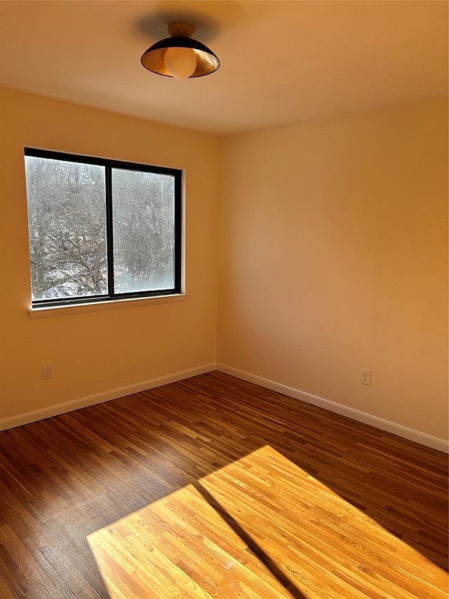 unfurnished room with hardwood / wood-style floors