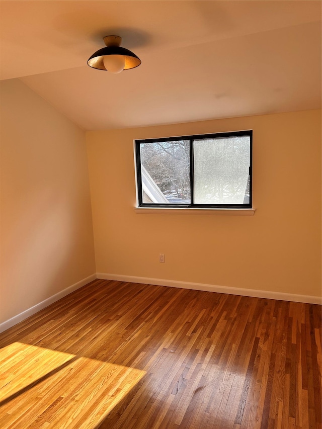 spare room with hardwood / wood-style flooring