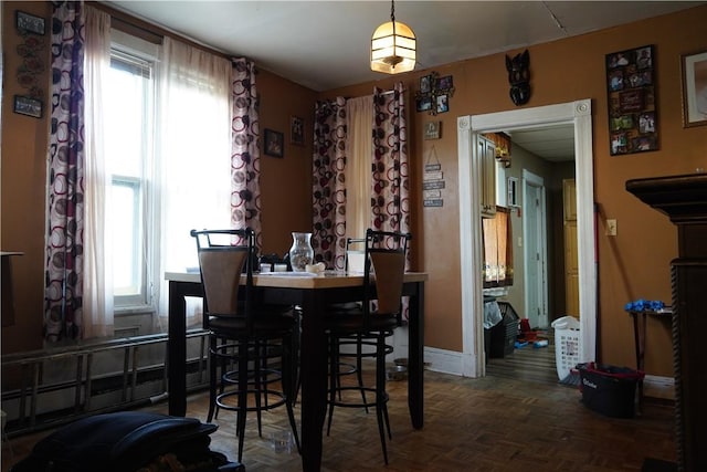 dining area featuring dark parquet floors