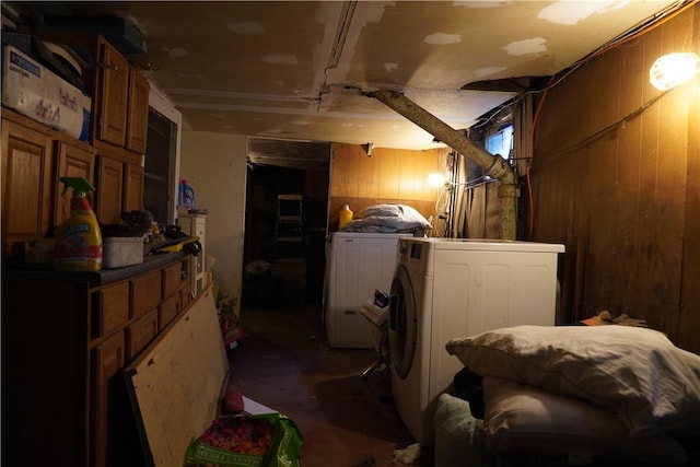 basement with wooden walls and washing machine and dryer