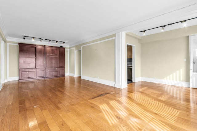 unfurnished living room with ornamental molding, rail lighting, and hardwood / wood-style floors