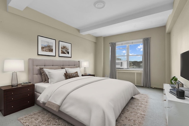 bedroom featuring beamed ceiling and light colored carpet