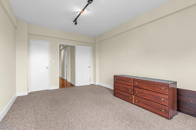 carpeted bedroom with track lighting