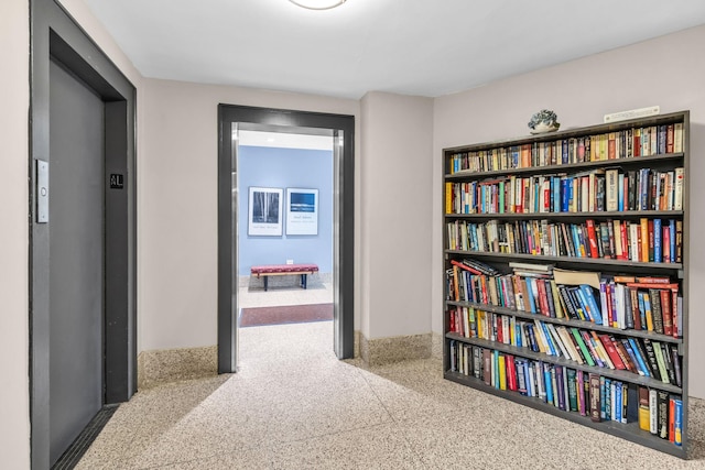 corridor featuring carpet and elevator