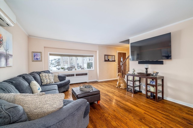 living room with hardwood / wood-style flooring, ornamental molding, radiator, and an AC wall unit