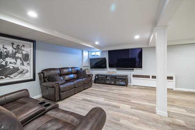 living room featuring wood-type flooring and ornate columns