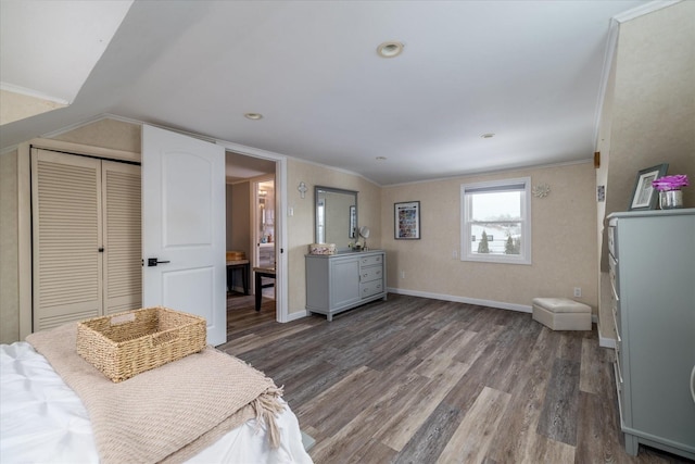 bedroom with ornamental molding, lofted ceiling, dark hardwood / wood-style floors, and a closet