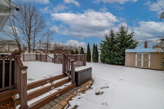 snow covered deck featuring a storage unit