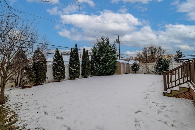 snowy yard with a storage unit