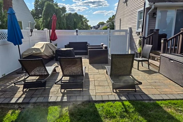 view of patio with outdoor lounge area and grilling area