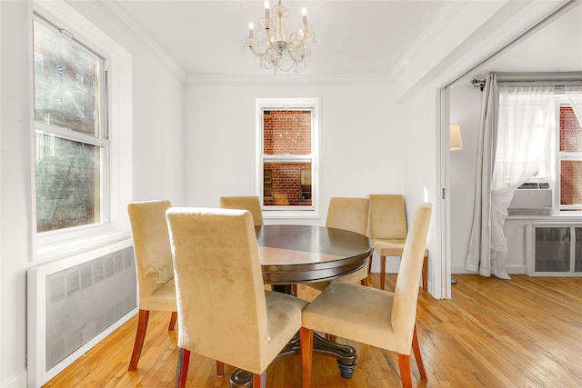 72-10 112th St Unit 3B, Forest Hills, NY 11375 - dining space featuring radiator heating unit, a chandelier, light wood-type flooring, ornamental molding, and baseboards