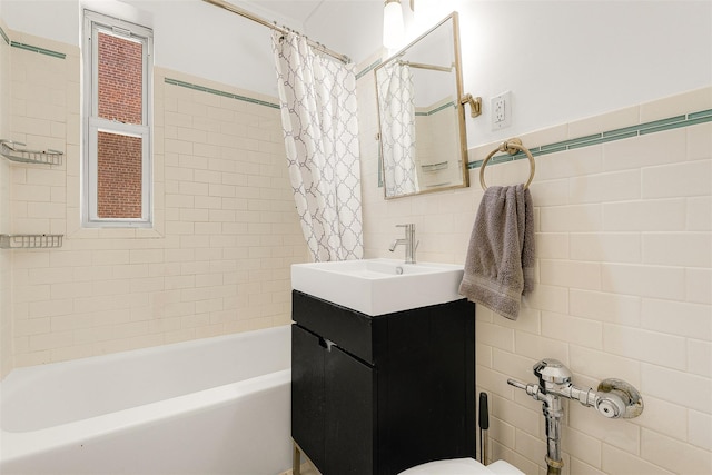 72-10 112th St Unit 3B, Forest Hills, NY 11375 - full bathroom featuring tile walls, shower / bath combo with shower curtain, vanity, and toilet