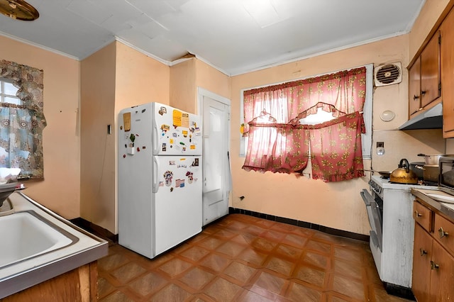 kitchen with crown molding, white appliances, and a healthy amount of sunlight