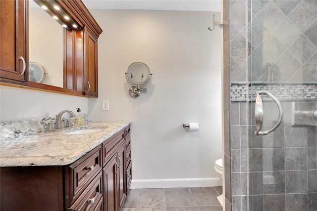 bathroom with vanity, tile patterned floors, toilet, and walk in shower