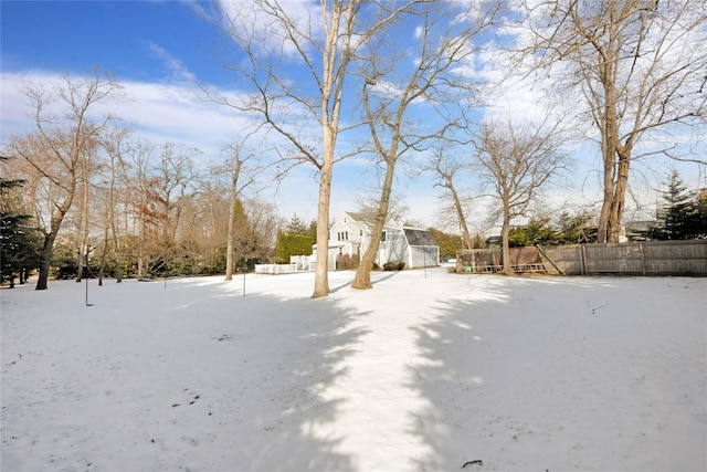 yard covered in snow with a trampoline