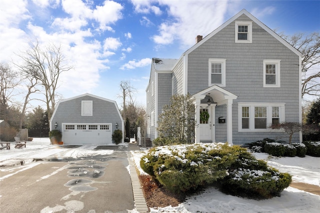 view of property featuring a garage and an outdoor structure