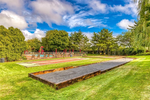 surrounding community with a playground and a lawn